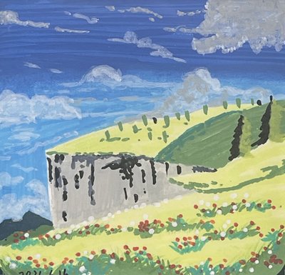 Wildflower meadow beneath a grassy cliff